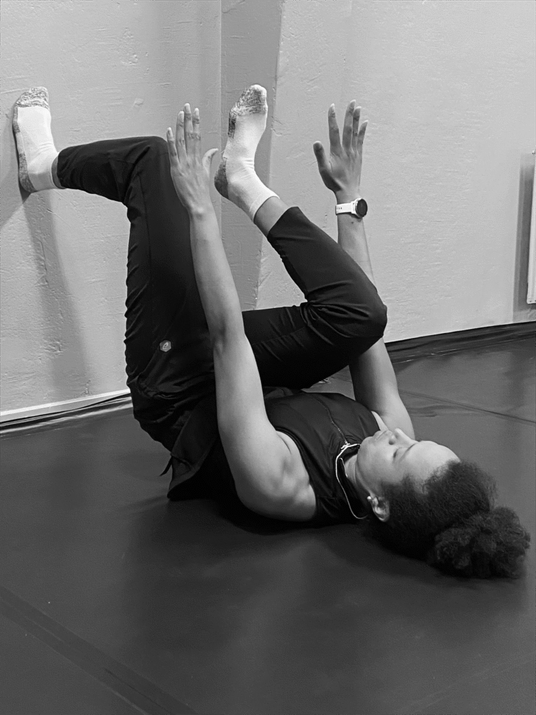 woman exercising with the wall on the floor